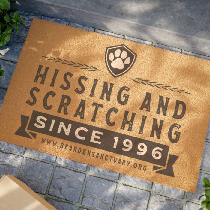 Doormat with "Hissing and Scratching" text.